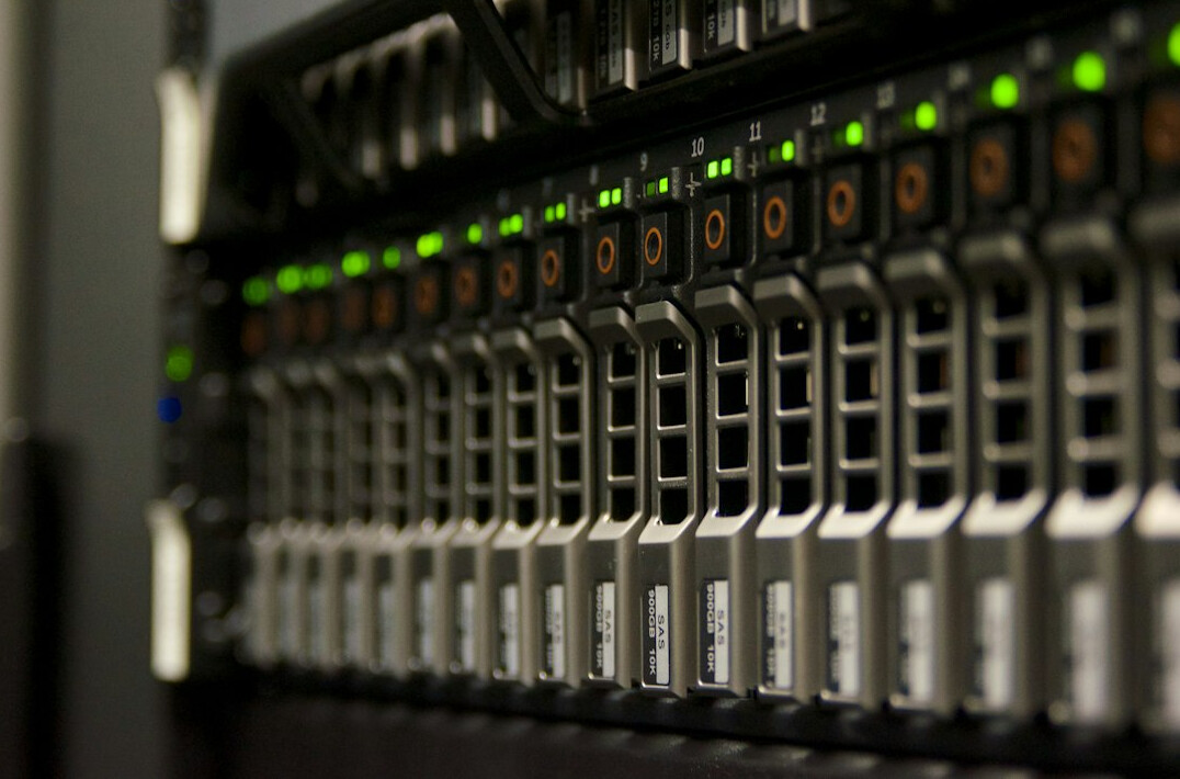 Rows of server racks in a data center with blue lighting