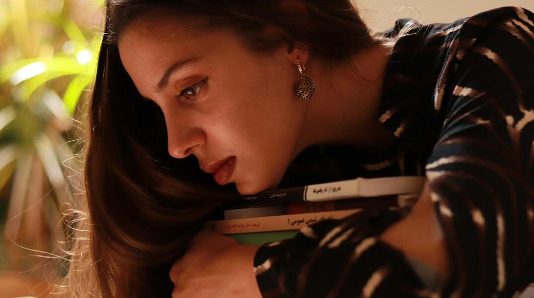 Portuguese woman journalist reviewing printed documents at her desk