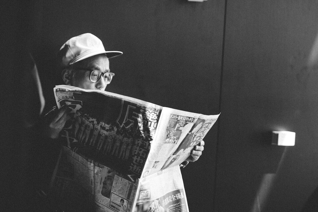 person reading newspaper